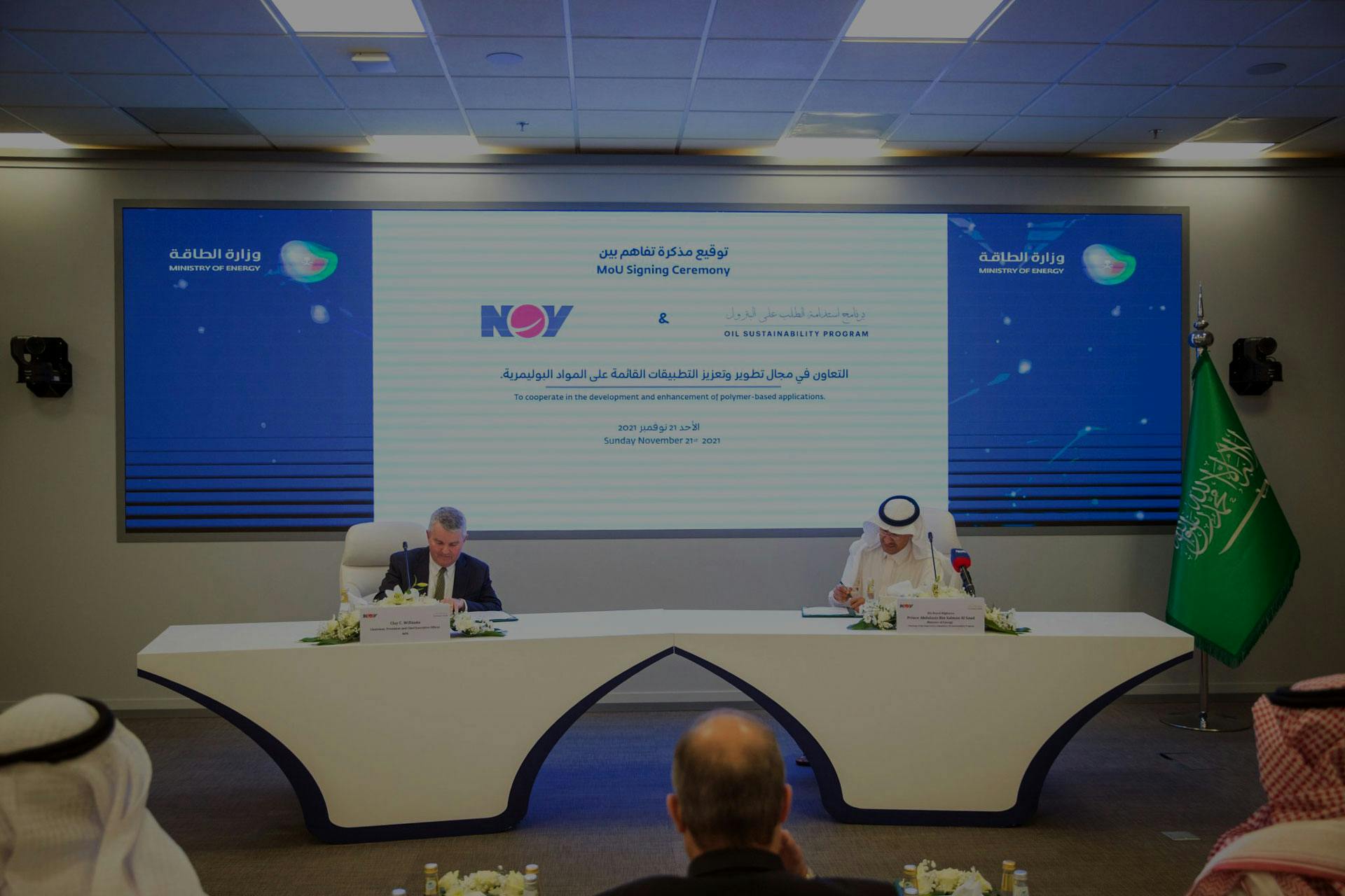 Clay C. Williams and HRH Prince Abdulaziz bin Salman signing MoU in front of a large screen