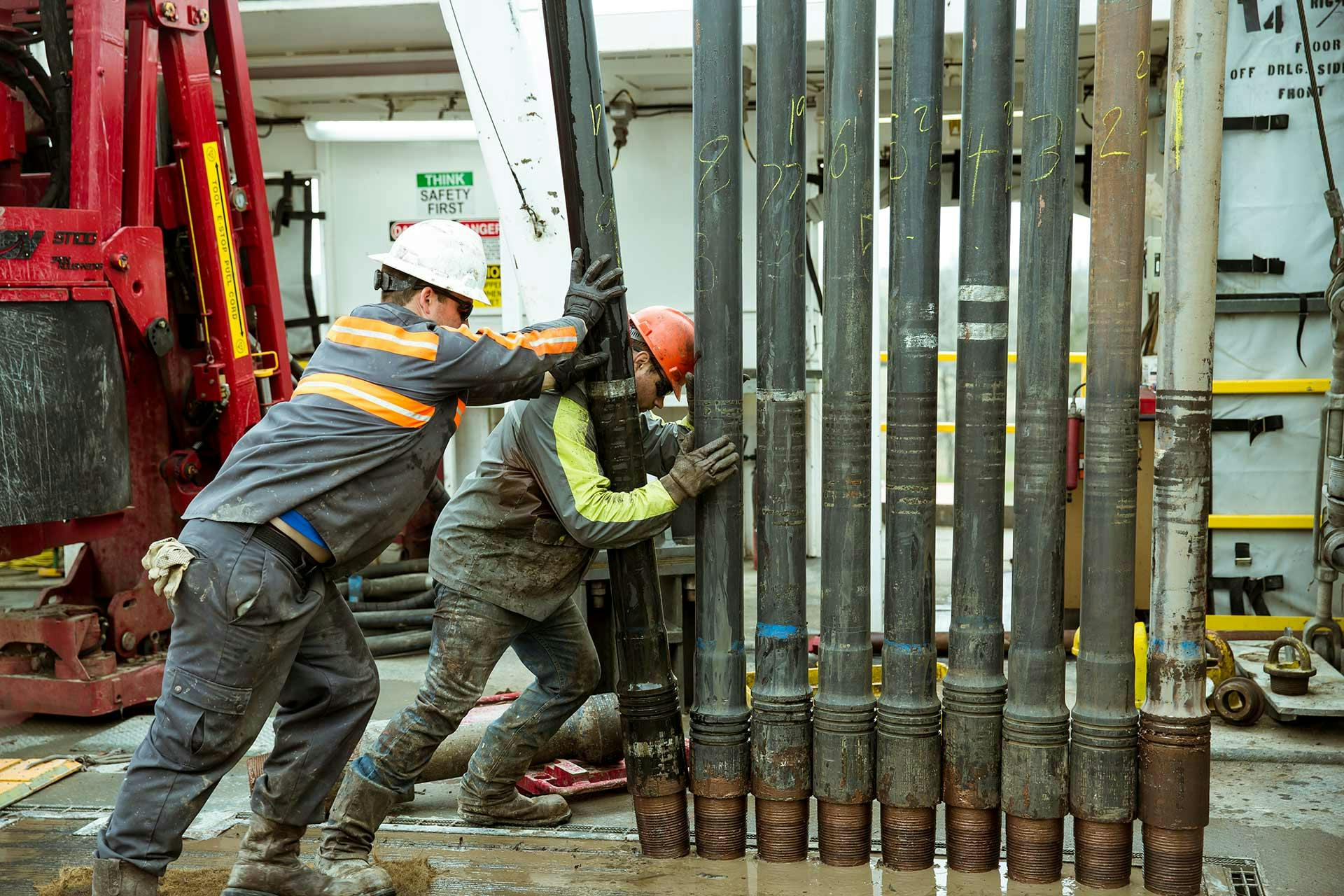 RDTC team stacking drill pipe at the test rig