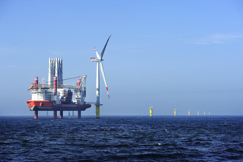 Offshore jackup rig with and wind turbine at sea