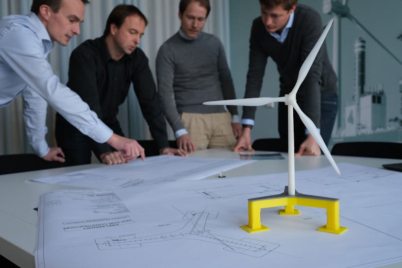 Engineering team reviewing wind turbine drawings