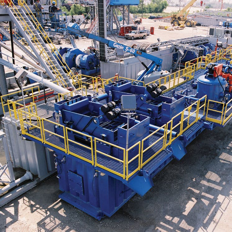 Image of a mud tank system outside of a facility, near other systems and machinery