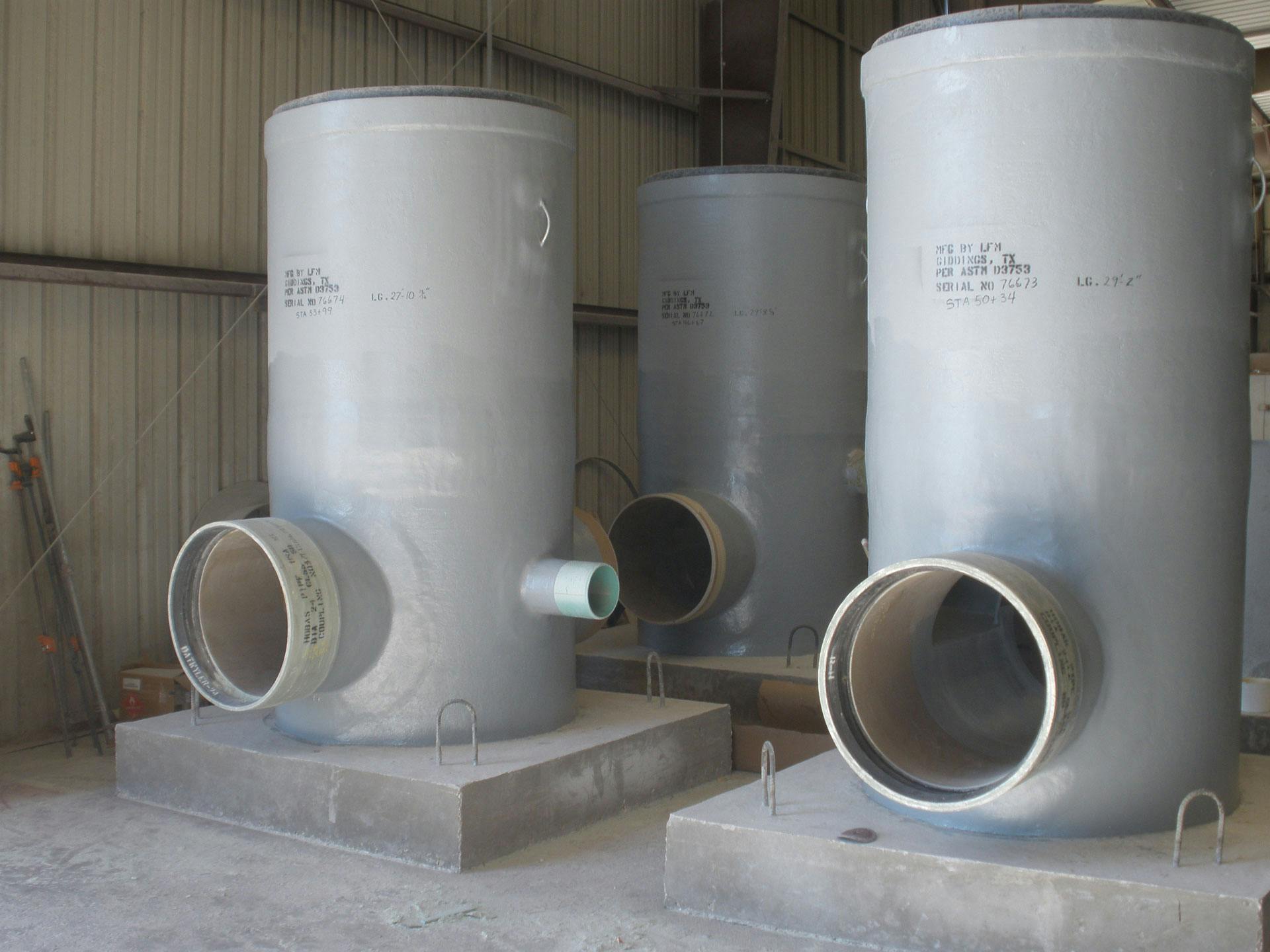 Three FRP pipes on concrete bases in a facility