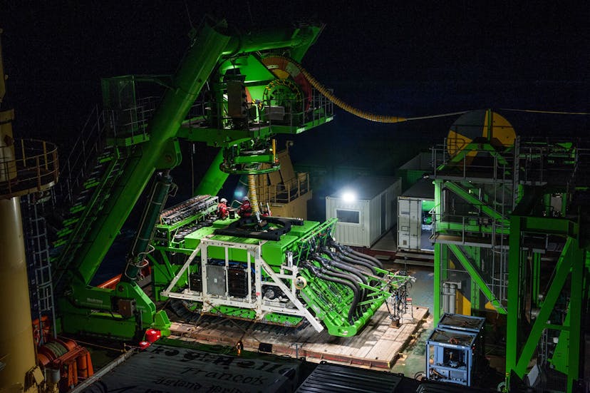 Green machinery on connector platform at night