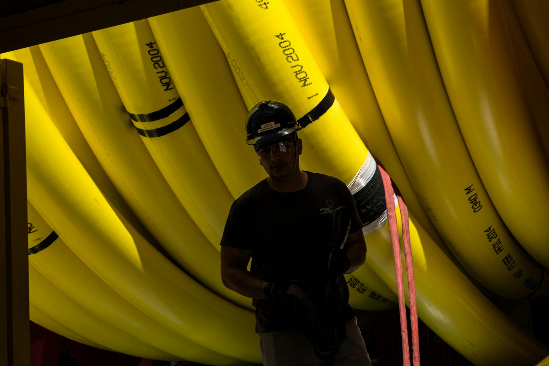 Technician standing in front of large coiled tubing