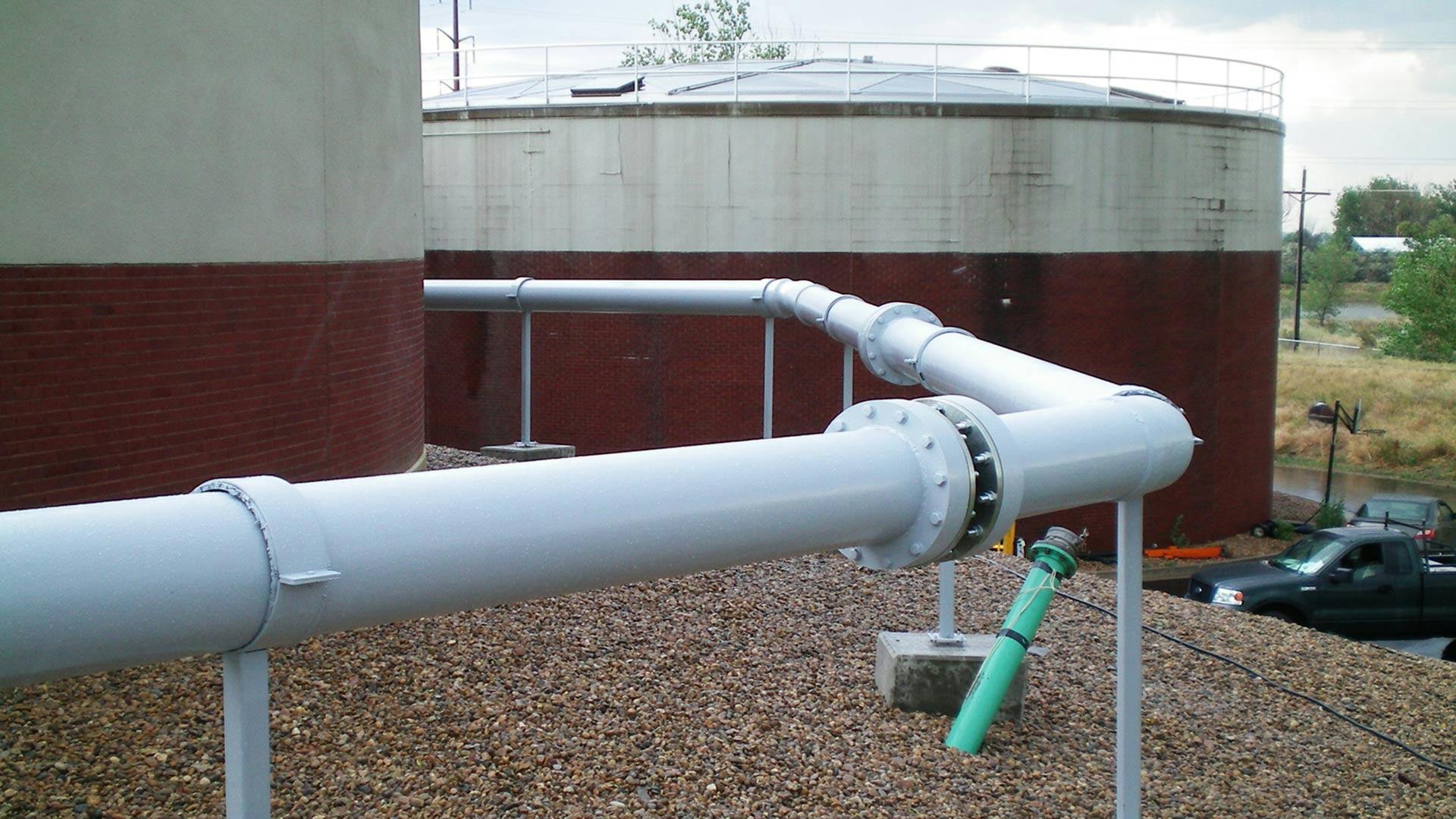 Displays a Centricast Fiberglass Pipe System on a facility roof