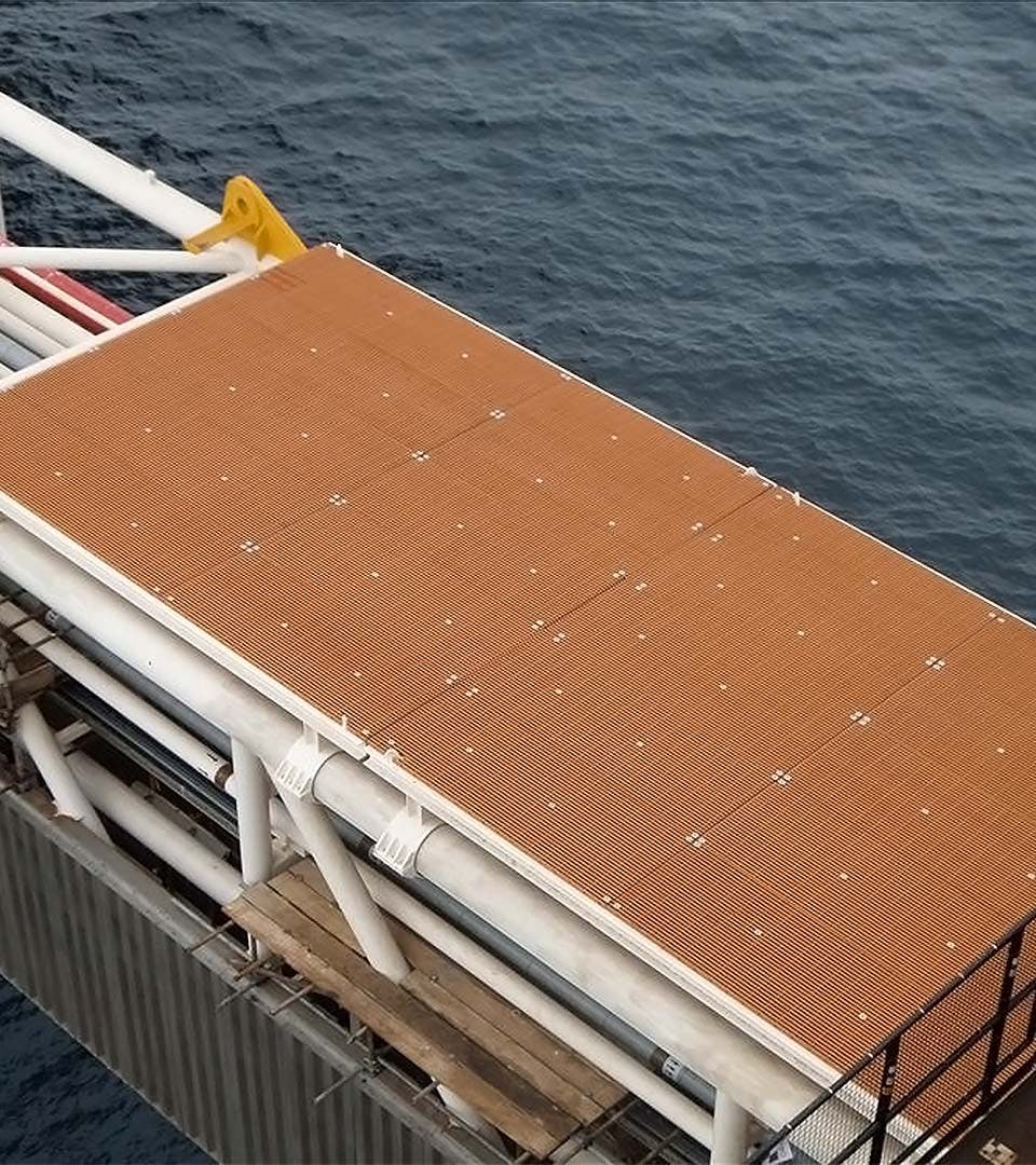 A fiberglass impact protection panel over the sea on an offshore rig