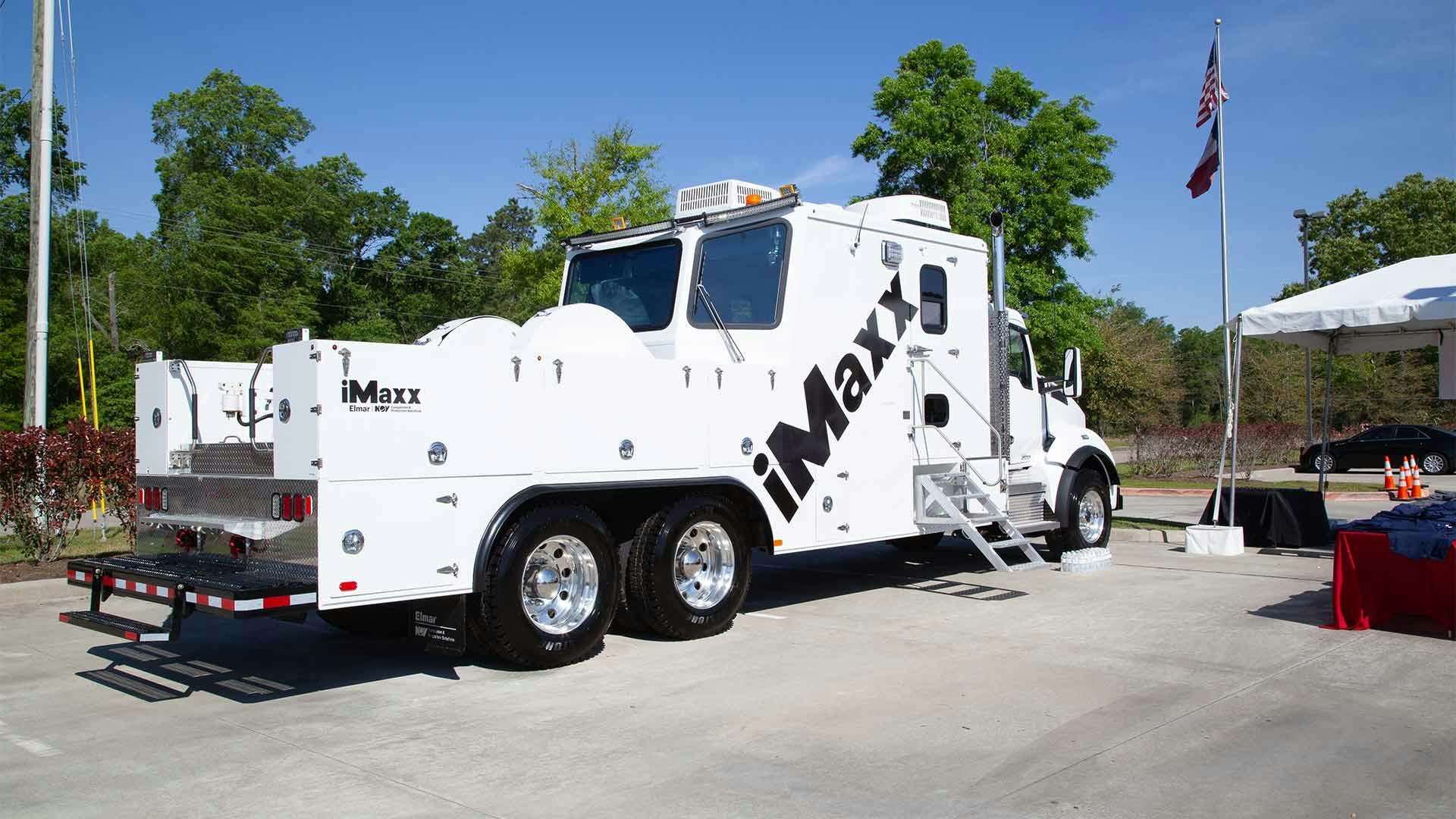 A back angle of an iMaxx series logging truck with an iMaxx logo decal