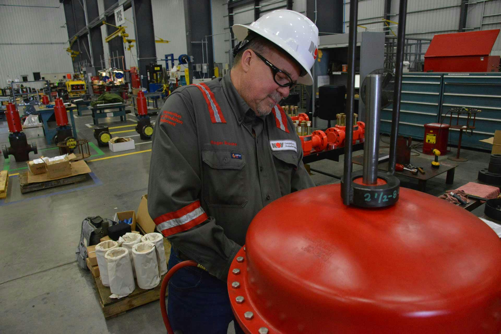 A technician works on Pneumatic Shutdown Valve in a manufacturing facility