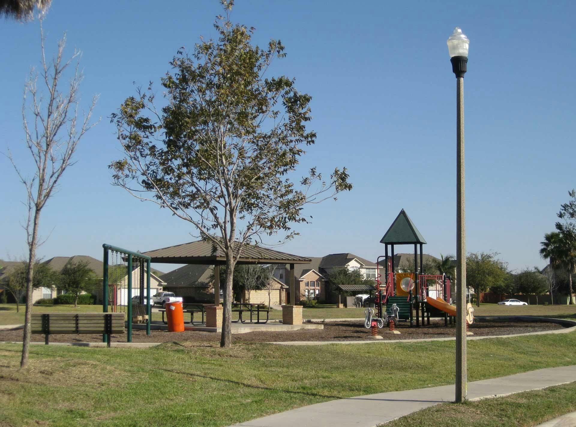 An Ameron Hexagonal S Series light pole near a children’s park