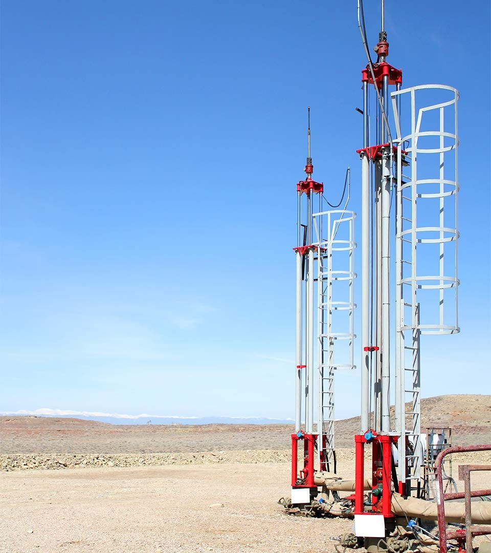 A pair of Morlift Hydraulic Rod Pumping Systems installed in an oil field