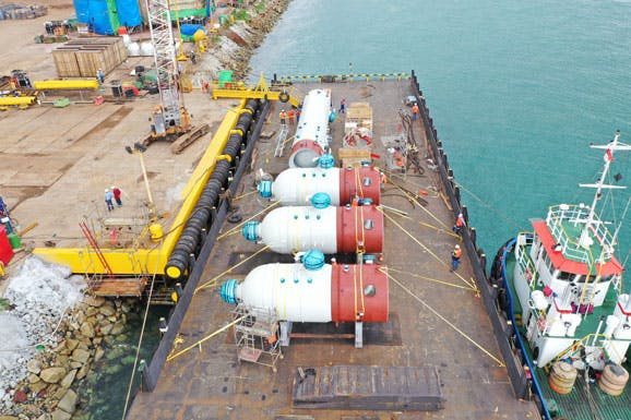 Row of pressure vessels, by the water