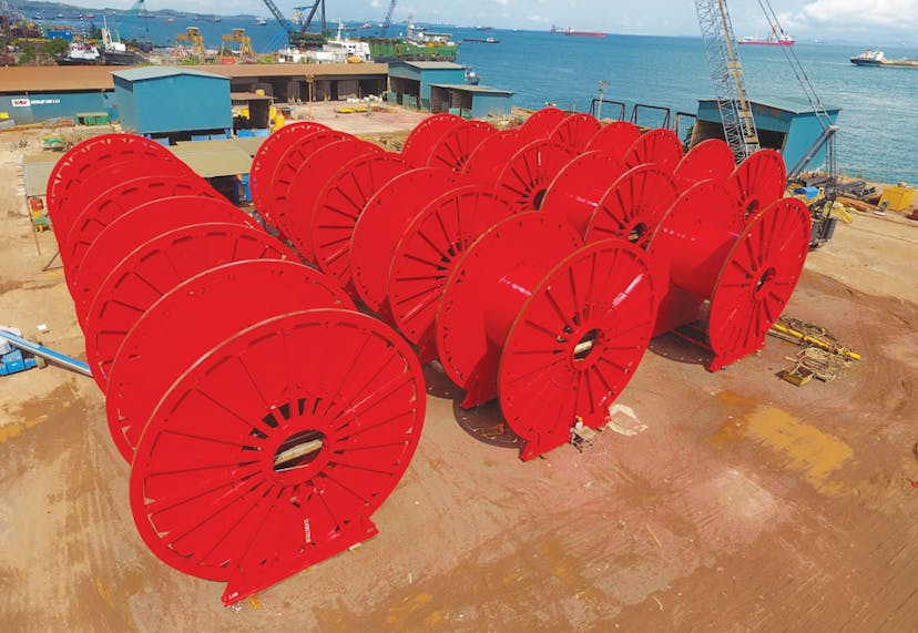 Rows of red hose reels with ocean in the background