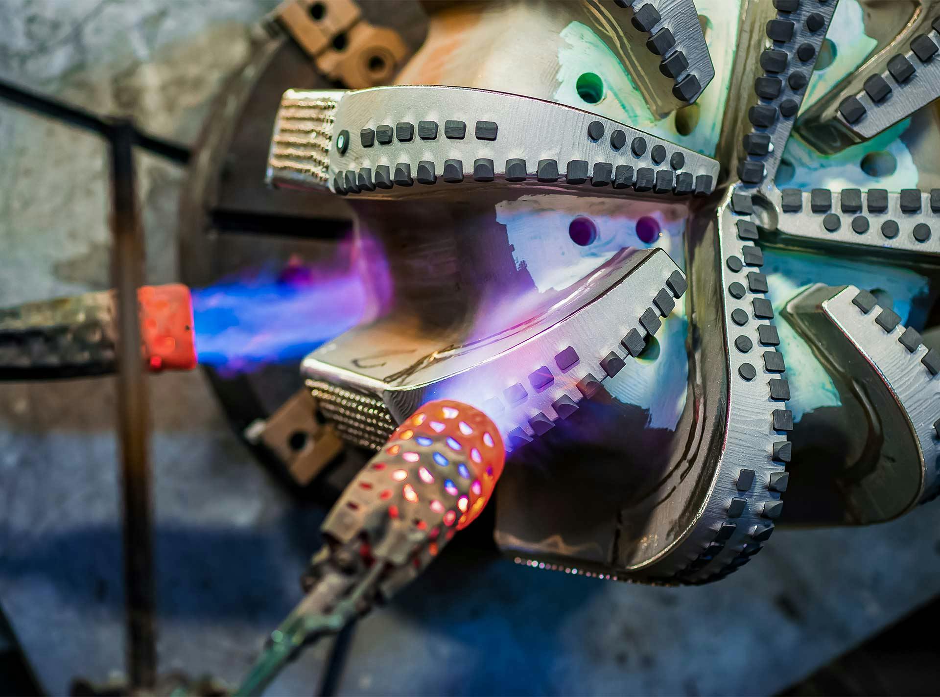 A drill bit being heated during repair