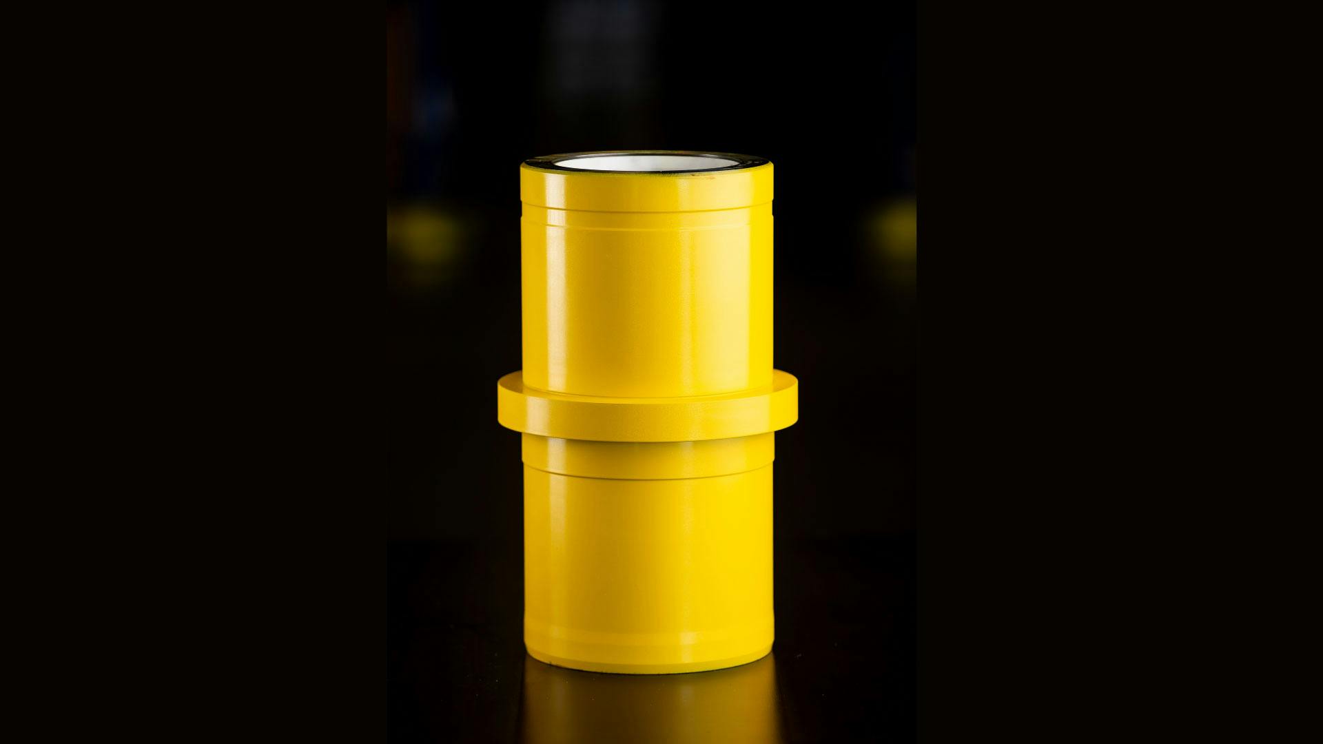 Single shot of a yellow ceramic liner with a black background