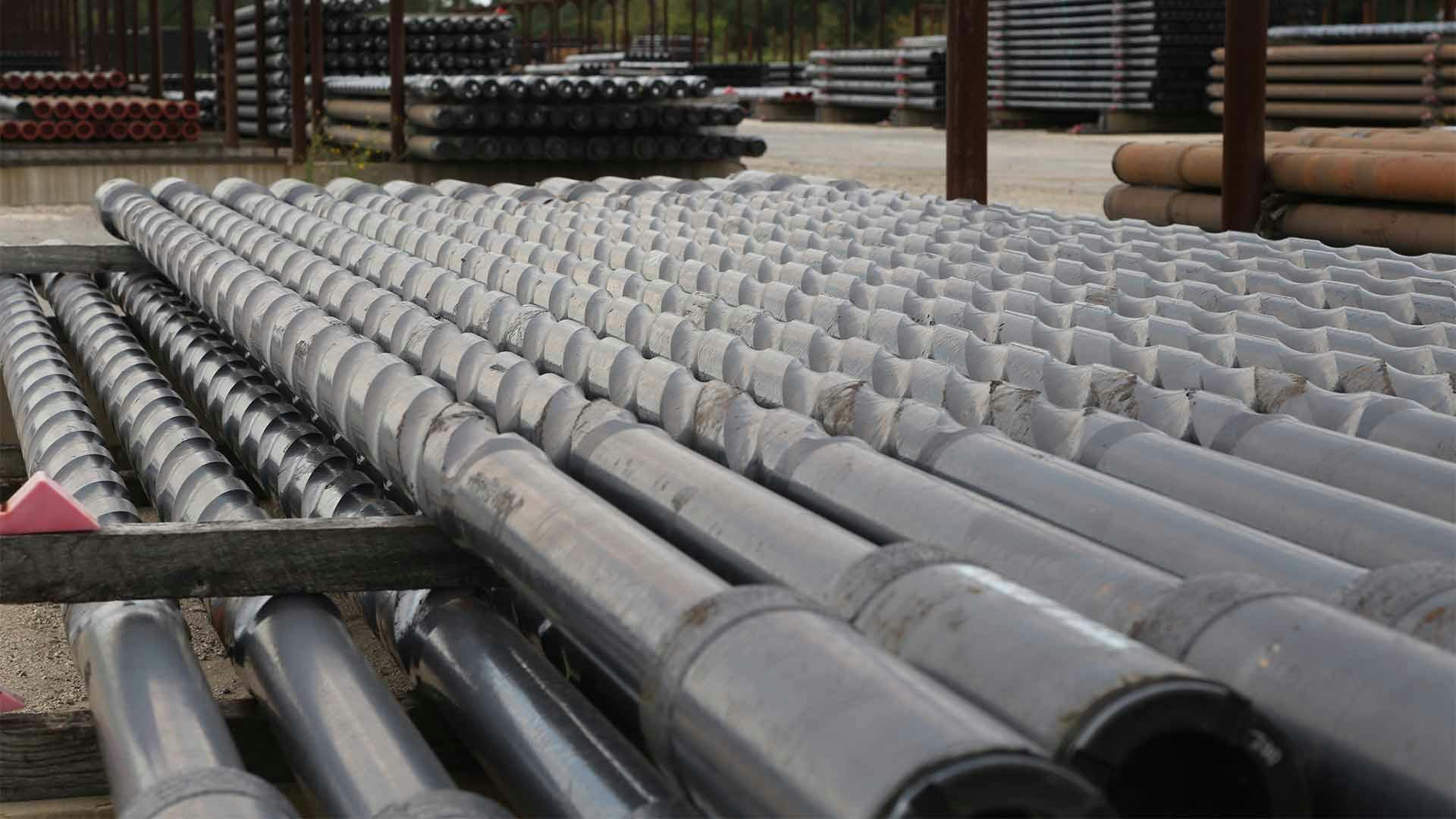 Grant Prideco's Heavy weight drill pipe is stacked in a manufacturing yard