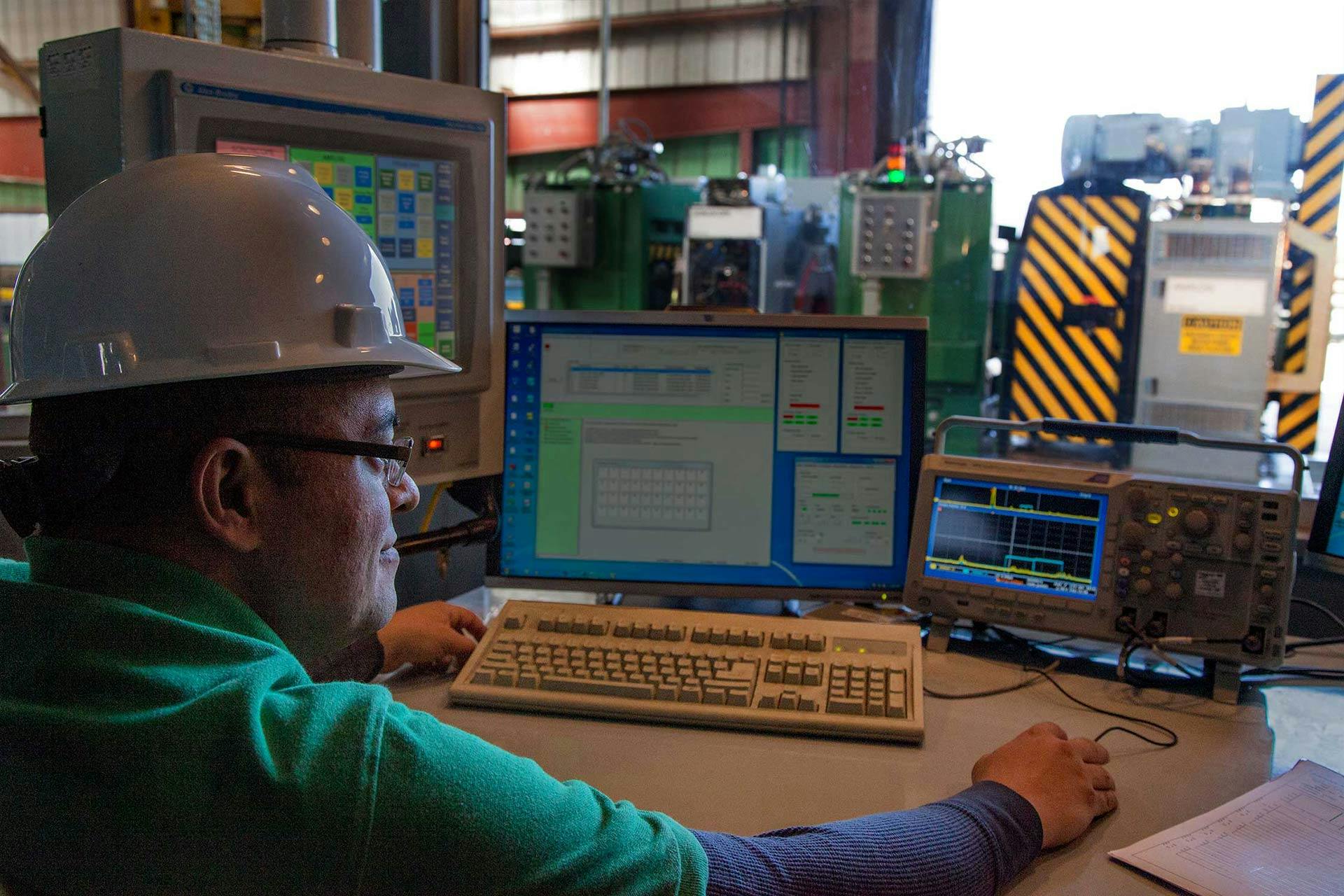 Man at computer performing mill inspection
