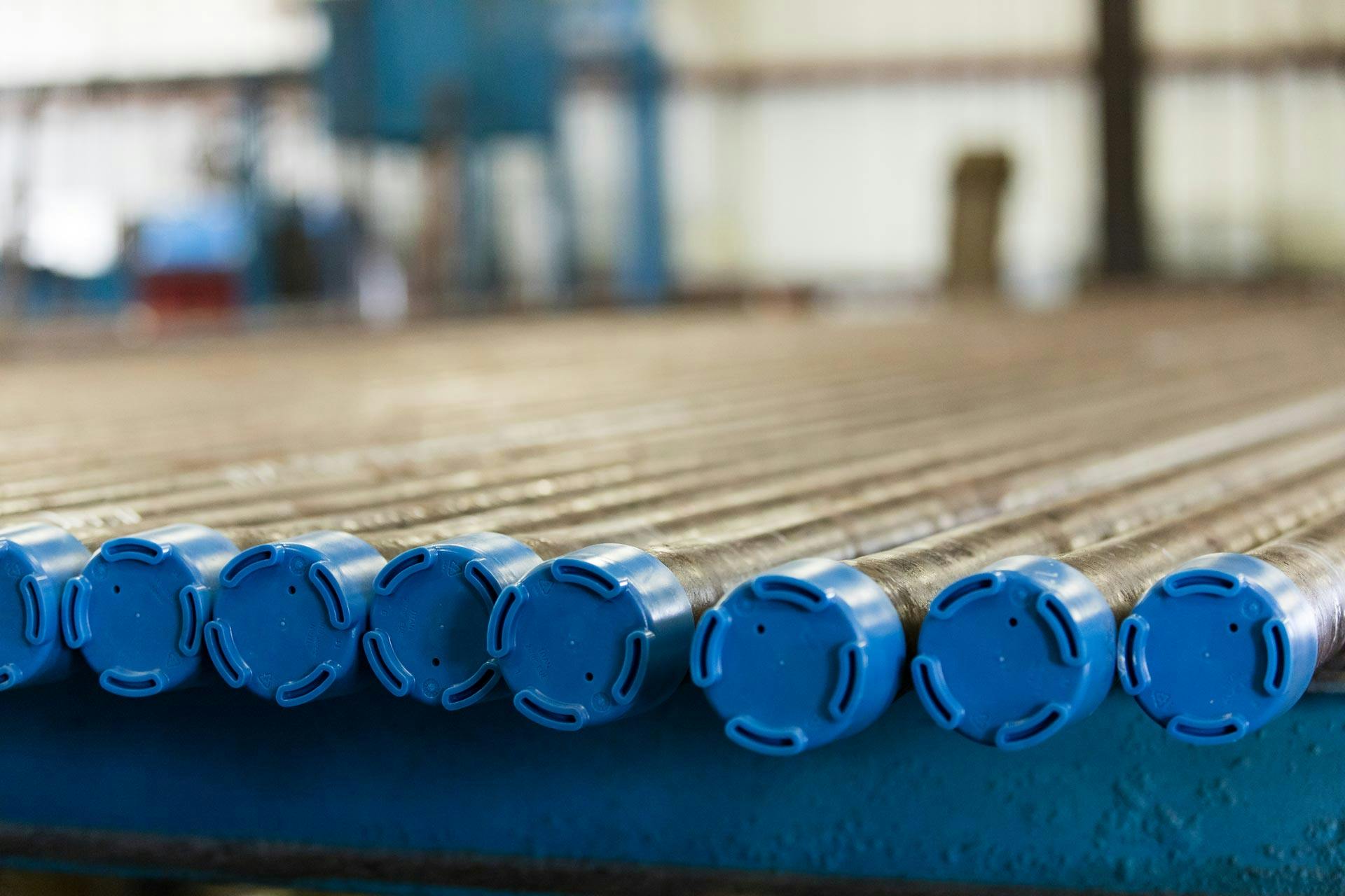 Blue Titan Tubing and Casing Thread Protectors in a line