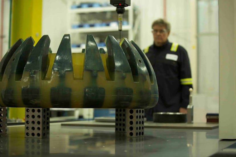 Close up shot of a deep water drilling elastometer, with NOV employee in the background