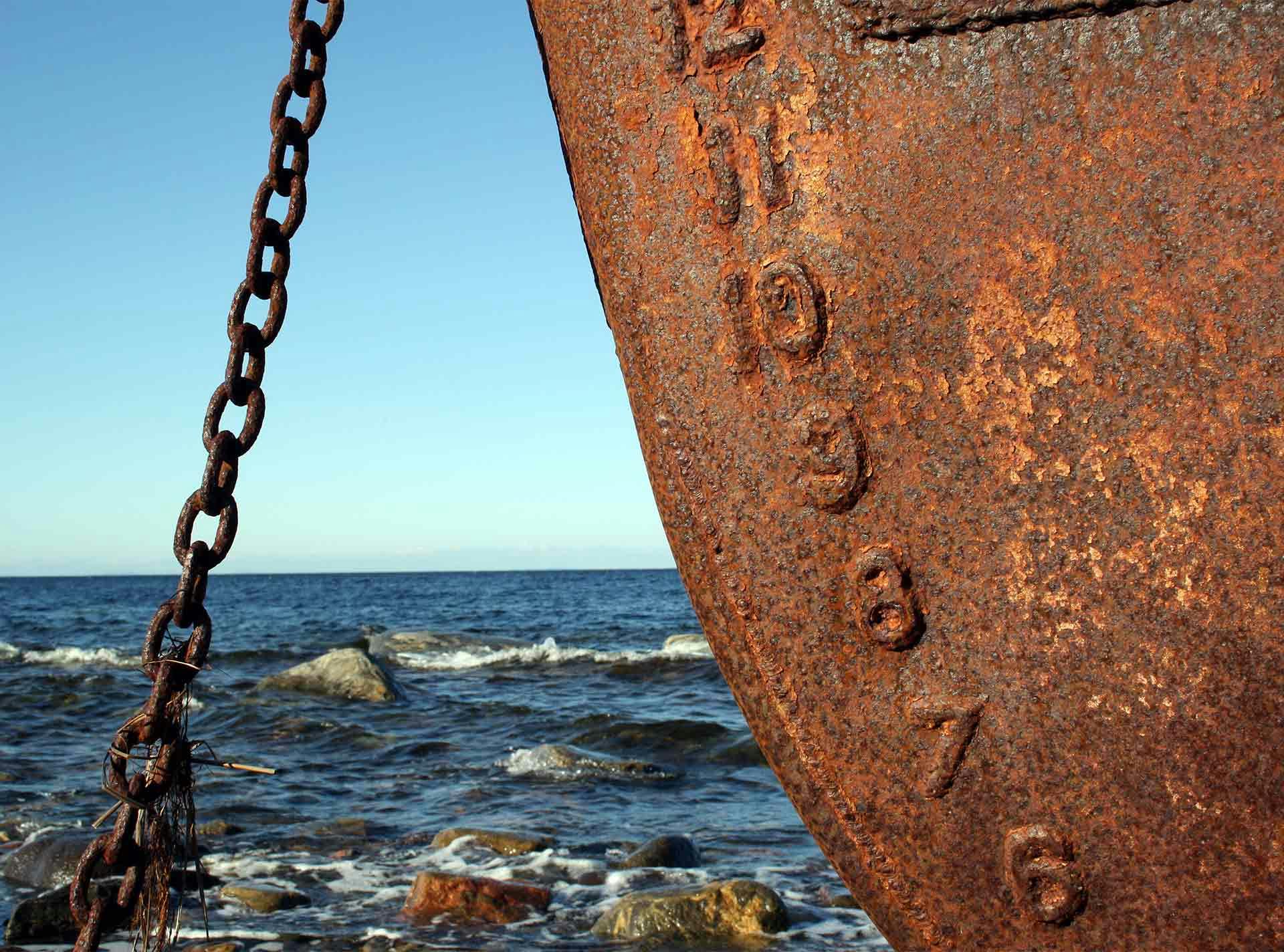 A closeup of a rusty ship, showing corrosion that can be avoided by using fiberglass