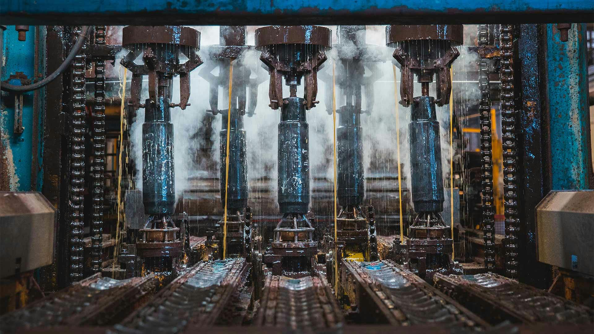 Steam curls around series of Grant Prideco pipes as they are cooled during manufacturing