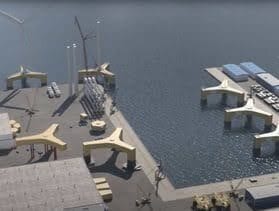 Aerial view of an industrial port with yellow Y-shaped foundations on land and in water.