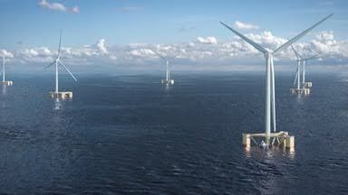 Multiple floating offshore wind turbines in the blue ocean under a partly cloudy sky.