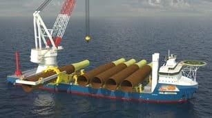 Offshore pipe-laying ship with a crane and large pipes on deck.