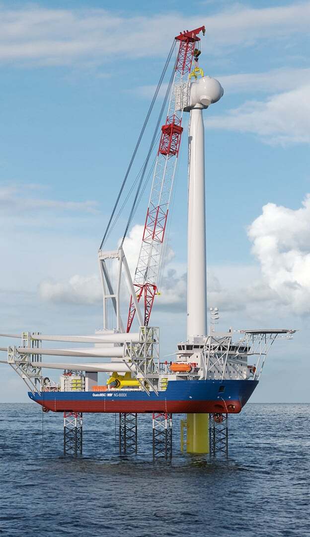 Offshore wind turbine installation vessel with a crane erecting a wind turbine, blades on deck.